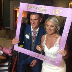 Wedding couple posing for Magic Mirror Photo Booth